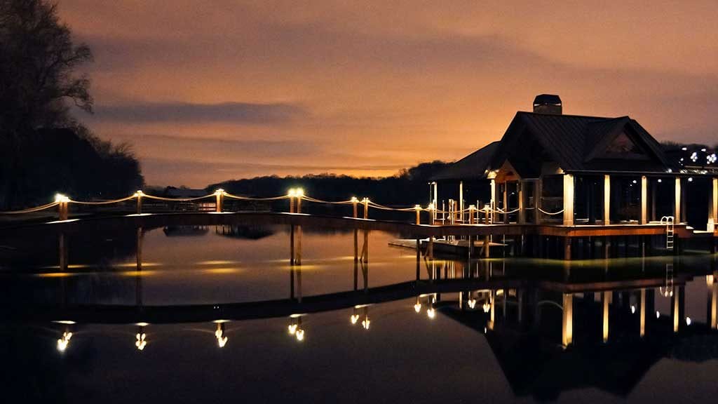 Custom dock at sunset with lights along the walkway and on the dock